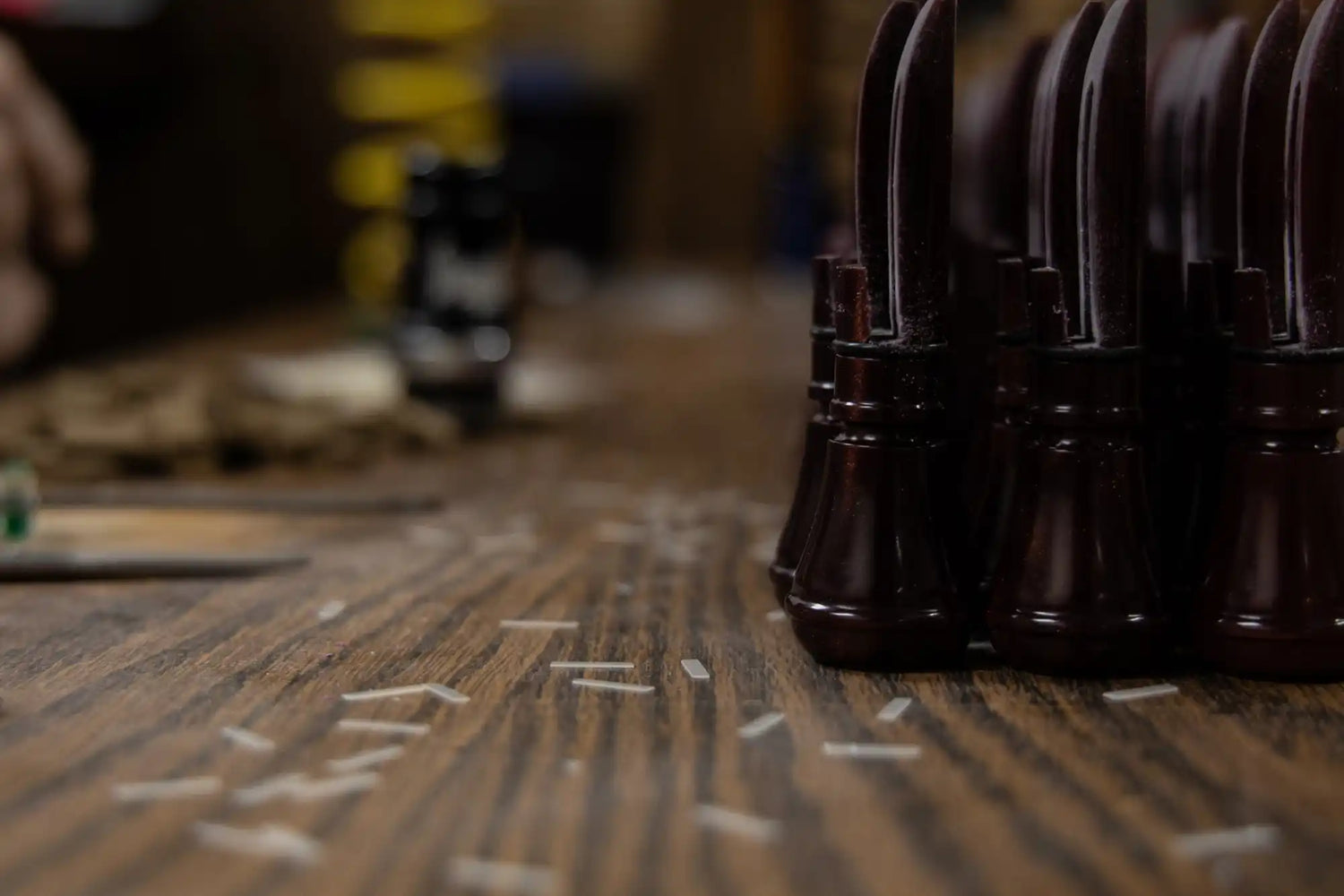 A row of dark brown, glossy knife handles.