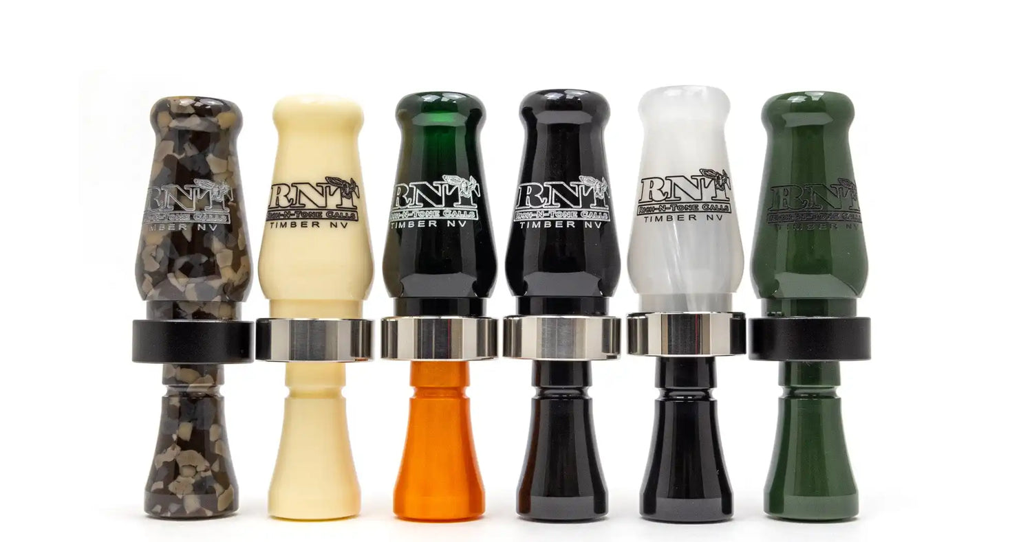 A row of six assorted duck calls.