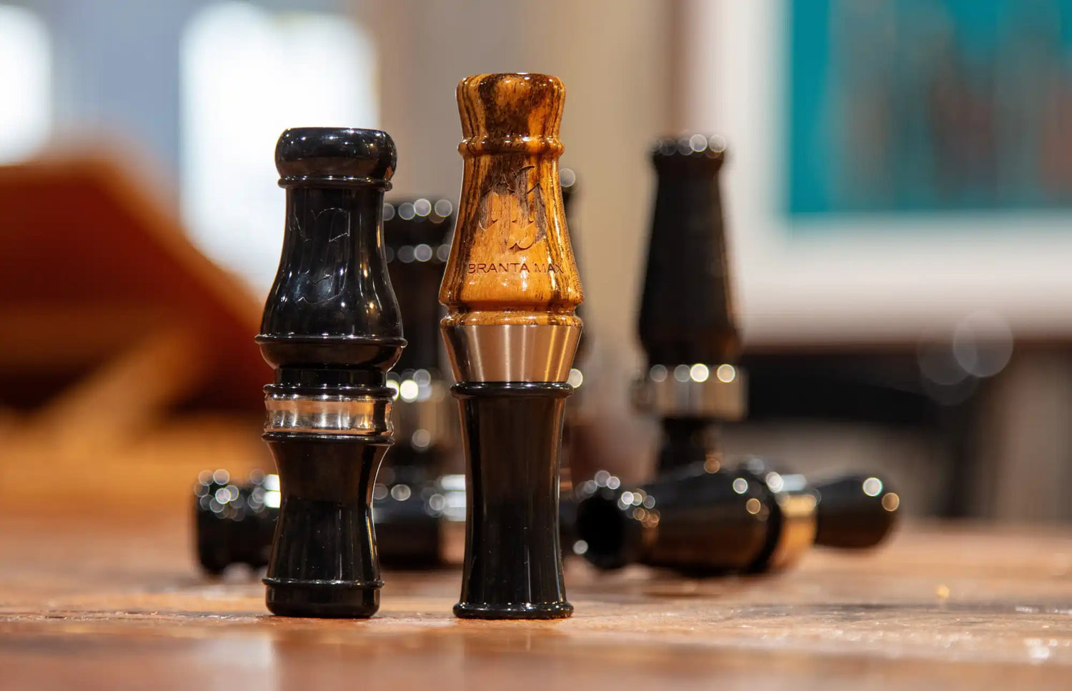 A set of black and bronze duck calls.